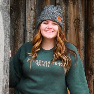 Stylish young woman wearing Headframe sweater and beanie