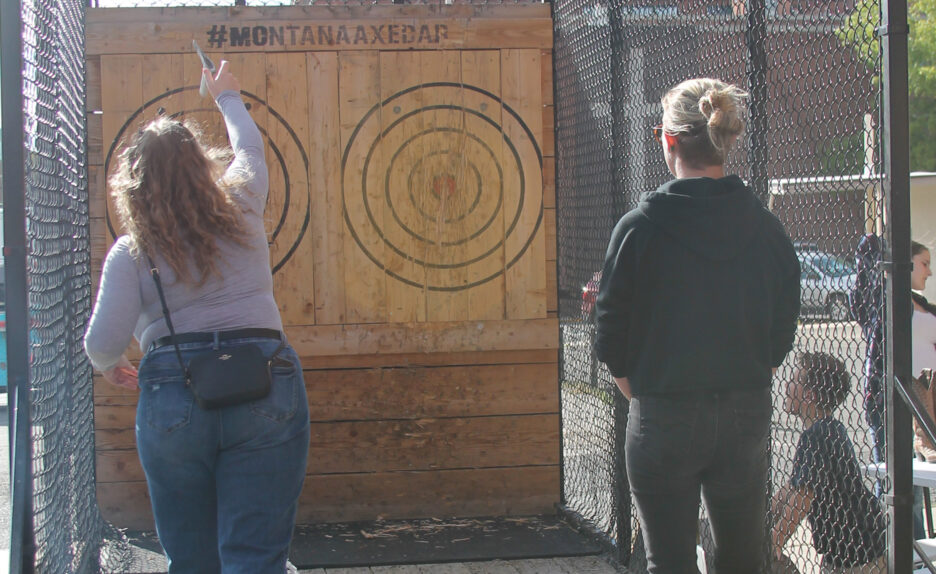 two young women throwing axes