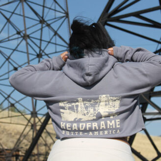 Stylist young woman wearing cropped hoodie with a graphic of Butte Montana