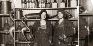 Two women moonshiners hold guns.