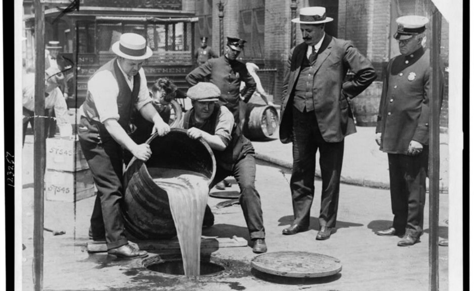 Men confiscated barrels of alcohol and pour it into the sewer