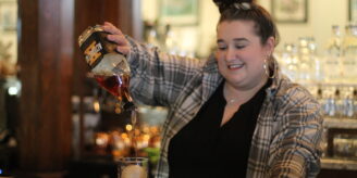 Woman-pours-glass-of-whiskey